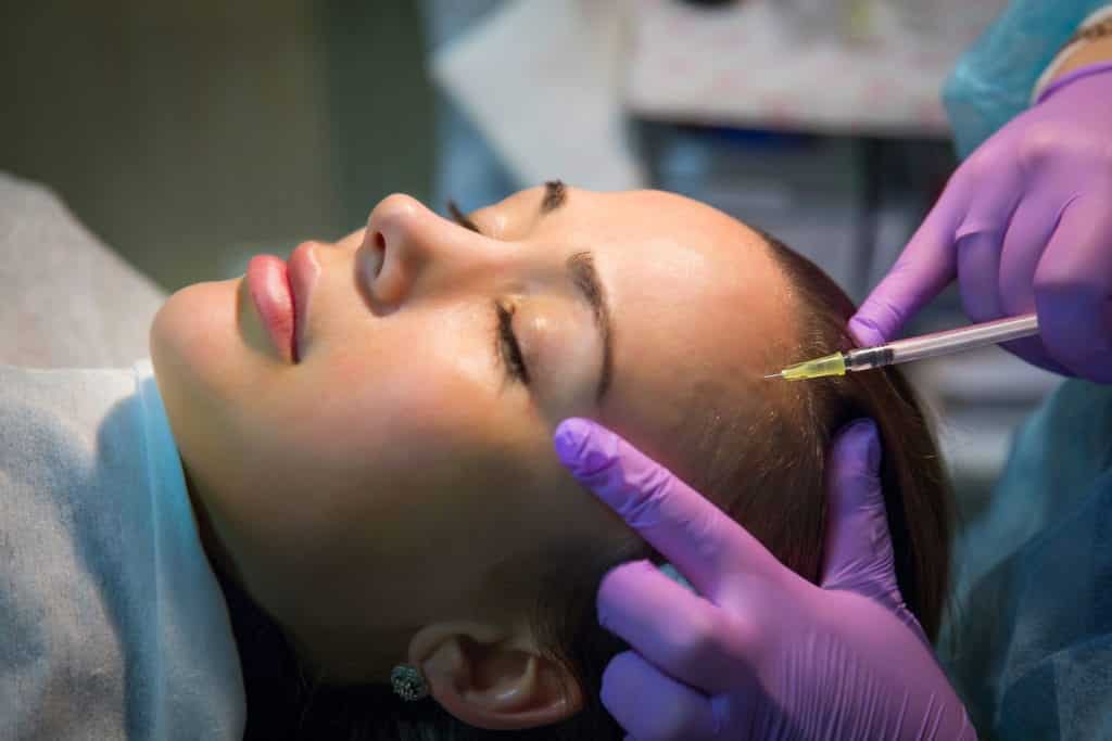 Botox being injected in forehead