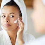 woman applying lotion | skincare routine